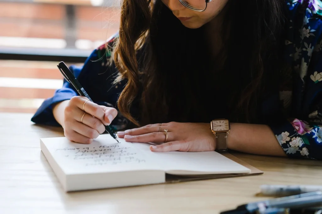 Woman journaling about new year's resolutions